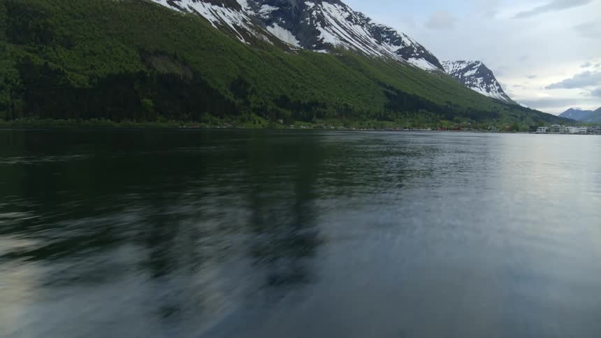 A lake in front of a mountain range