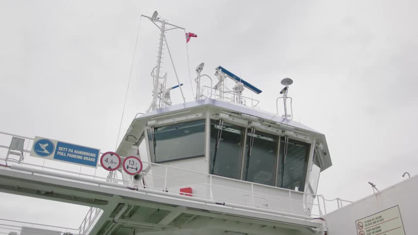 Norwegian flag blows in the wind aboard a ferry
