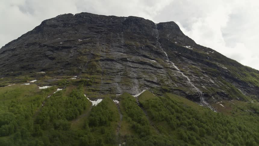 Water running down the slopes of a mountain in Norwegian fjords