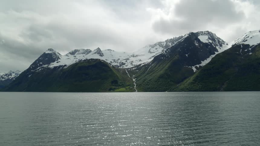 Snow capped mountains in Norwegian fjord