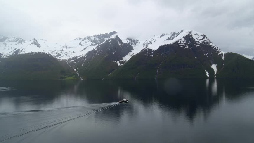 Aerial view of ferry passing between Norwegian fjords