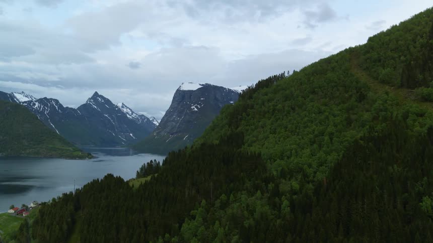 Beautiful aerial view of Norwegian fjord land with snow capped mountains and glacial waters