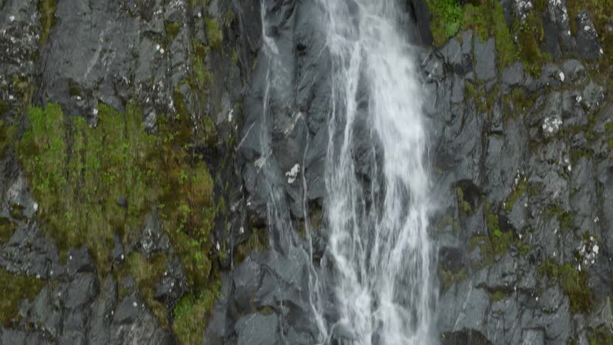 Aerial view of waterfall cascading down cliffside in Norway
