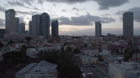 A large city with high rises under a dawn sky