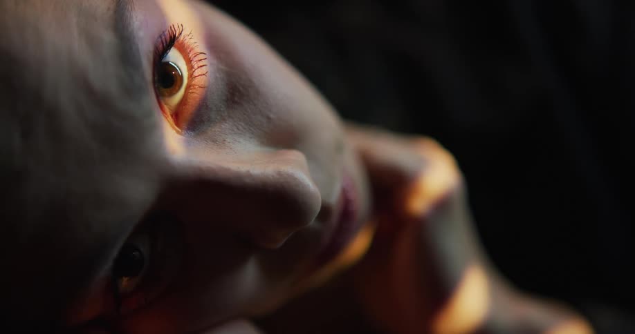 Close up view of a womans face is displayed