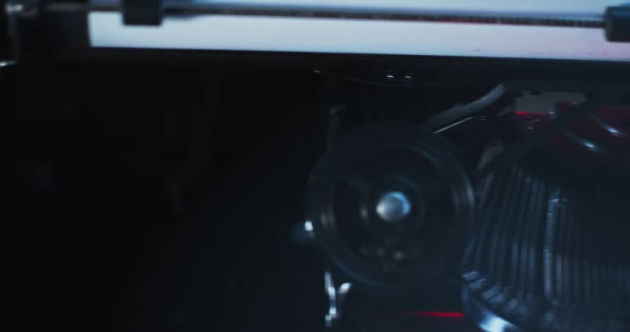 Light shines on the type bars and carriage of an old typewriter