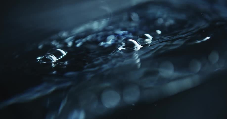 Light reflects on the water as it ripples and moves and bubbles rise to the surface