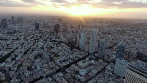 Aerial view of a large city at sunset