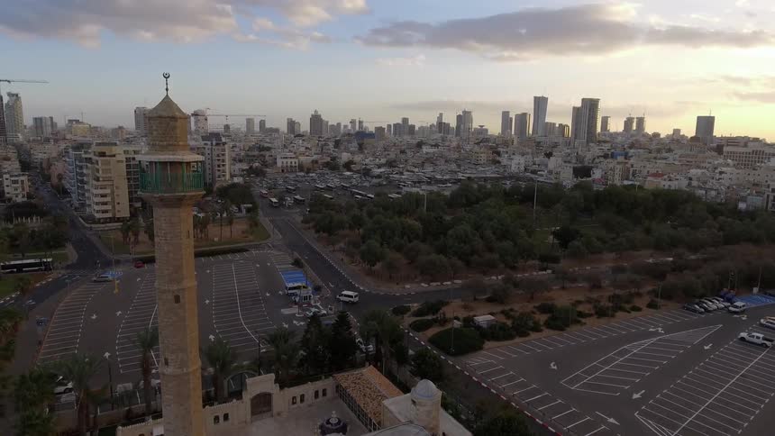 An aerial footage of a towerd in the middle of city