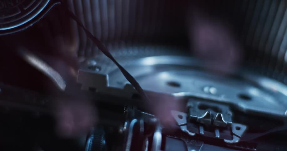 Close up of red and blue flashing lights reflecting over the parts of a vintage typewriter