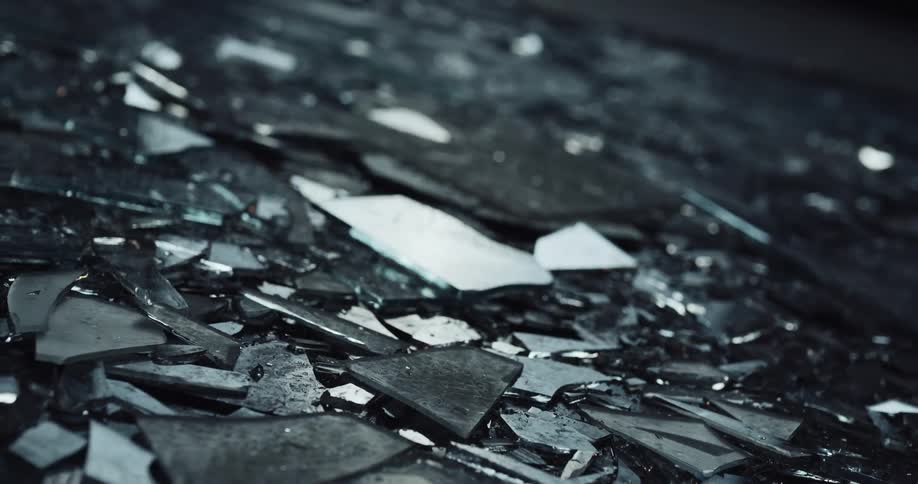 A pile of broken glass is on the ground