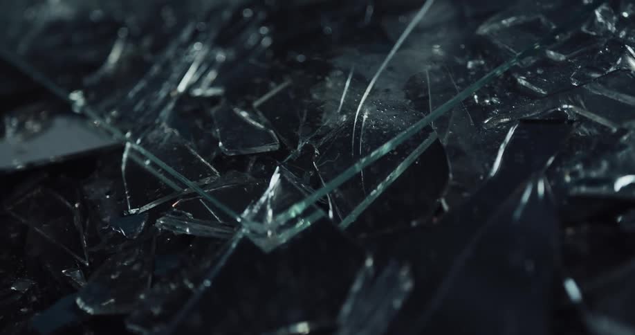 Broken cracked safety glass in shards on the ground