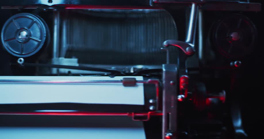 Close up of red and blue flashing lights reflecting over the parts of a vintage typewriter