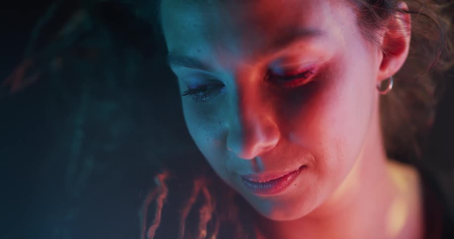 A woman smiles softly showing a dimple