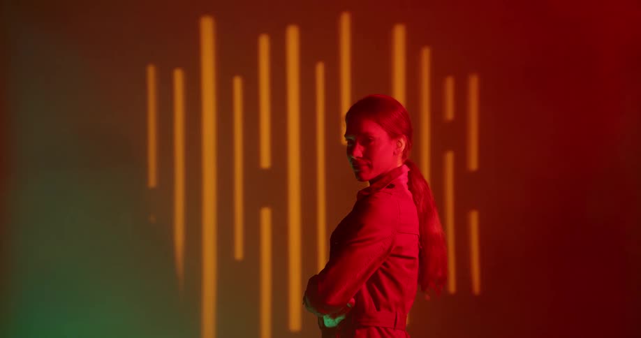 A woman is standing in a room by herself