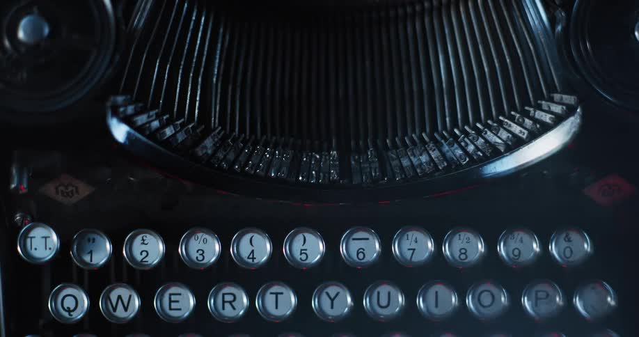 Light shines on the keys and type bars of an old typewriter