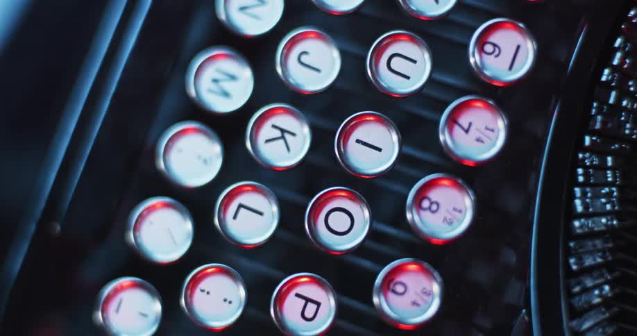 Close up of the red light reflecting on the keys on a vintage typewriter keyboard