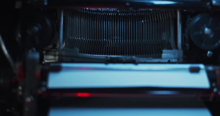 Type bars are moving on a vintage typewriter as its being used