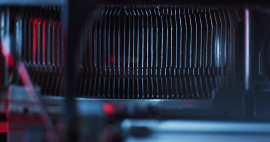 Close up of the typebars of a vintage typewriter under blue lights