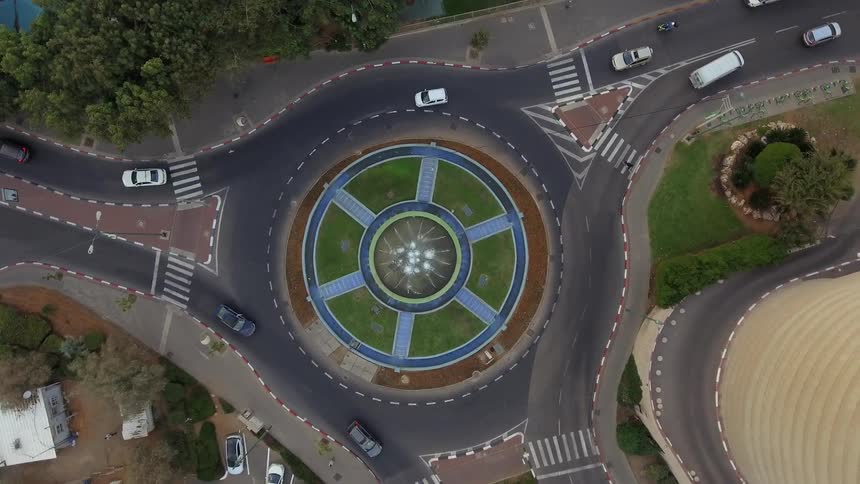 Aerial view of cars driving on a roundabout