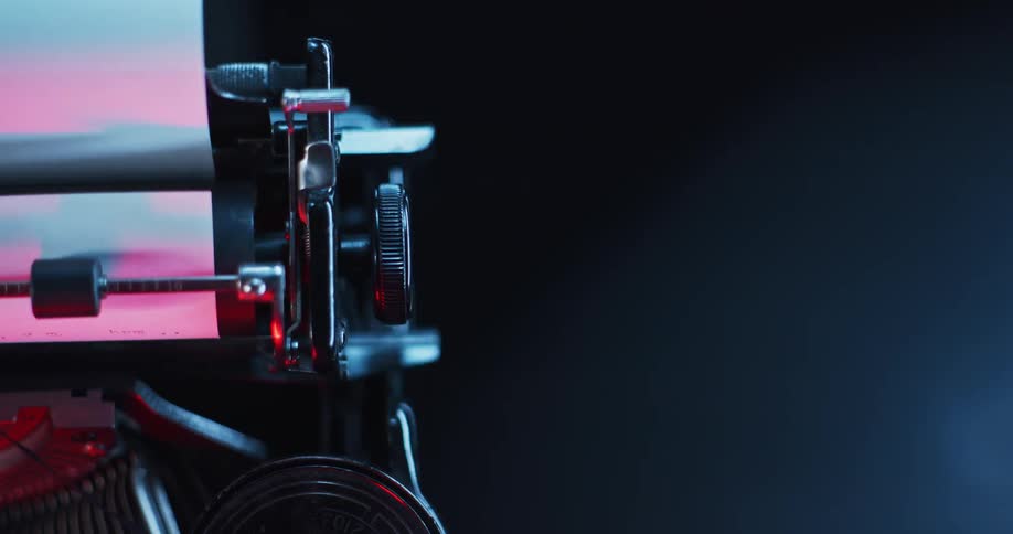 The carriage of an old typewriter is moving to the left
