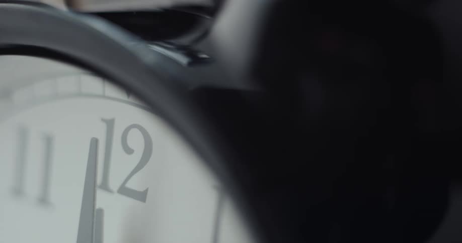 The hands of an analog clock are both on number twelve