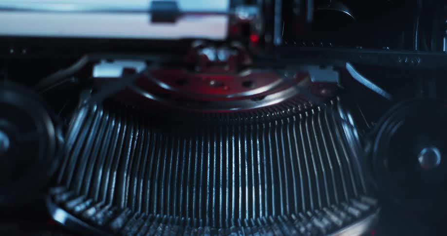Light shines on the type bars of an old typewriter