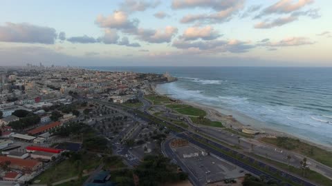 A road runs along the shore of a coastal town