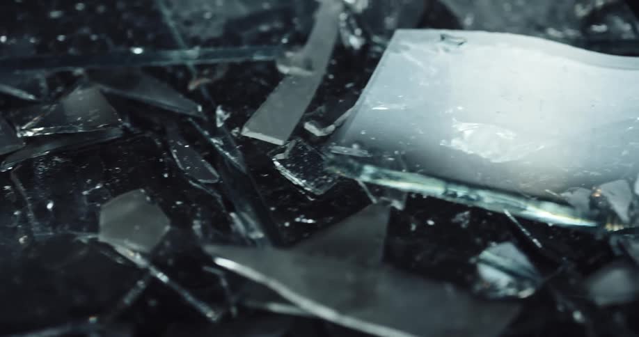 Light shines on shards of broken glass on the ground