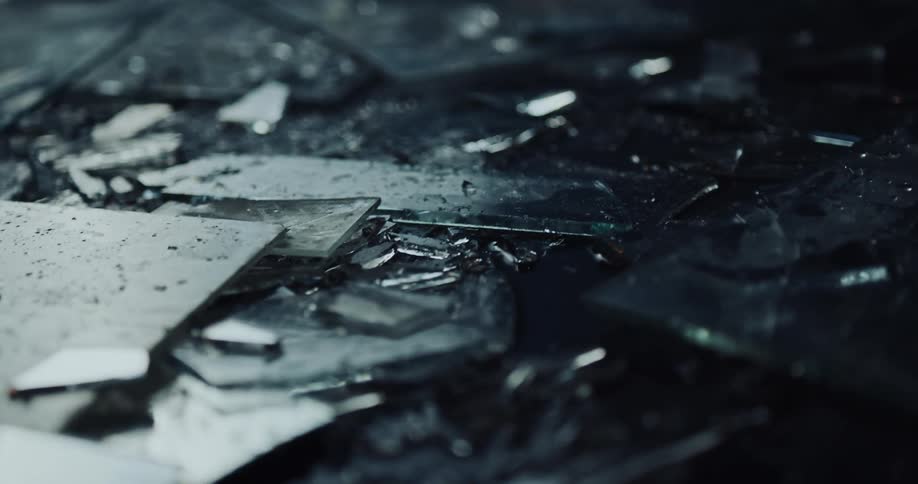 The ground is littered with fragments of broken glass at crime scene