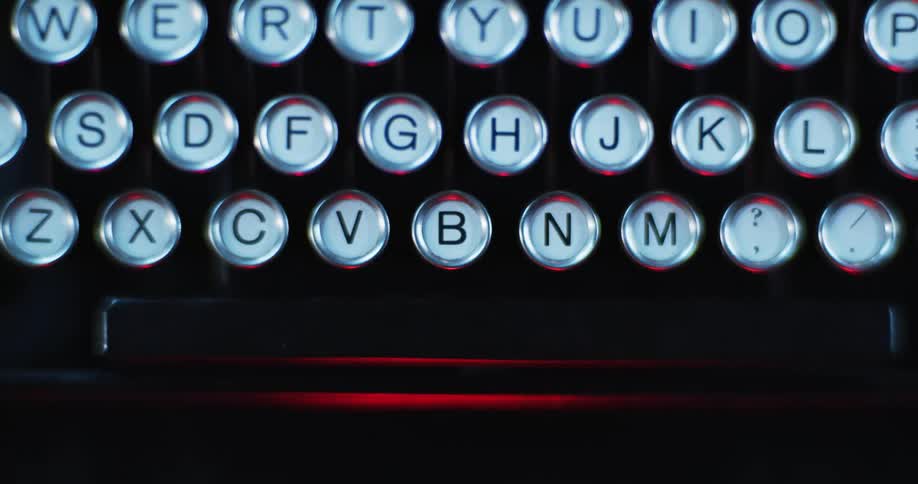 A red light shines over a typewriter