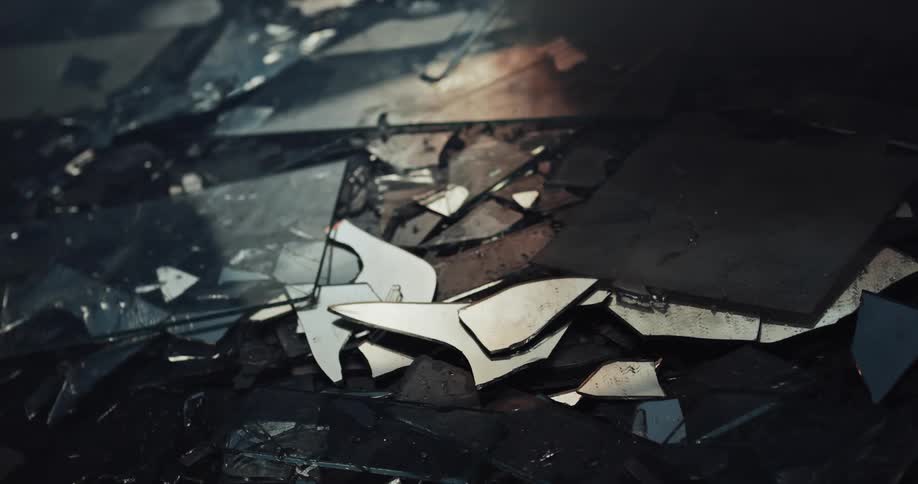 The ground is littered with fragments of broken glass at crime scene