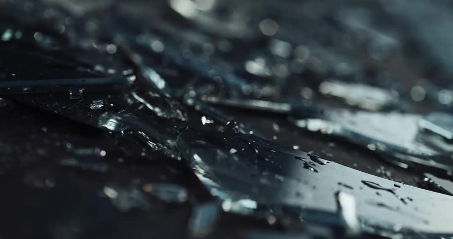 Wet glass shards are lying all over the ground