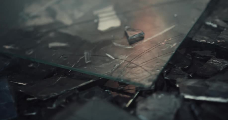 The ground is littered with fragments of broken glass at crime scene