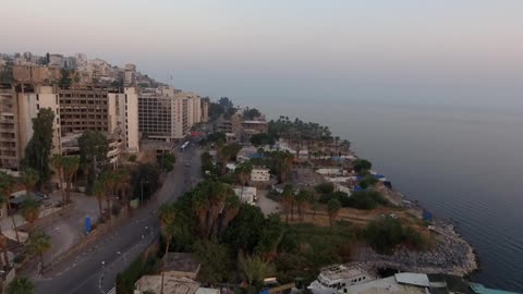 A car travels on the road of this coastal city