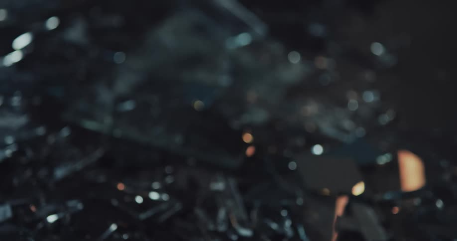 The ground is littered with fragments of broken glass at crime scene