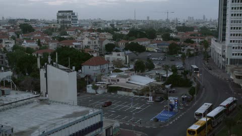 Cars travel down a street in a city