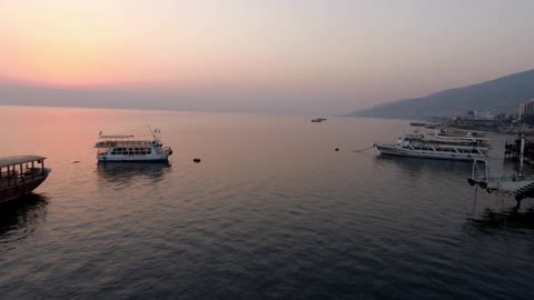 Boats in the water at sunset