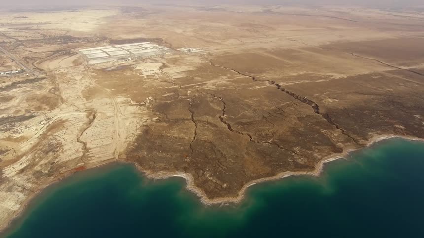 A scenery of a desert and ocean
