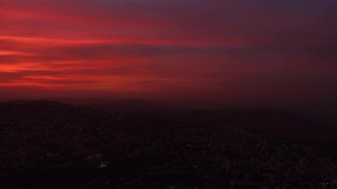 The clouds of this skyline at dawn are a red color