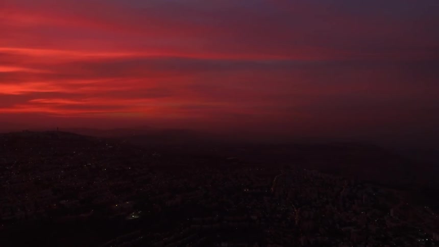 The clouds of this skyline at dawn are a red color