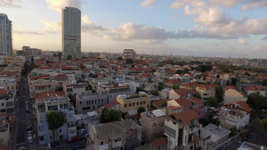 A city has two very tall buildings in the distance