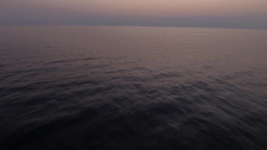 Travelling over the ocean on a cloudy evening