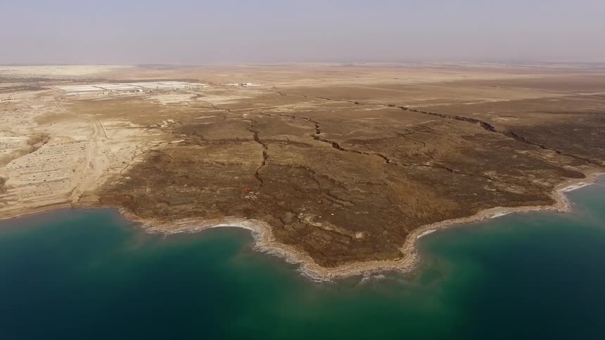 A wide desert area near an ocean
