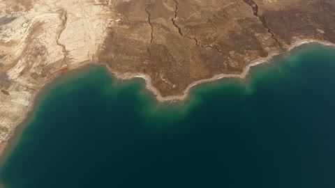 Aerial view of a green sea  coming to shore
