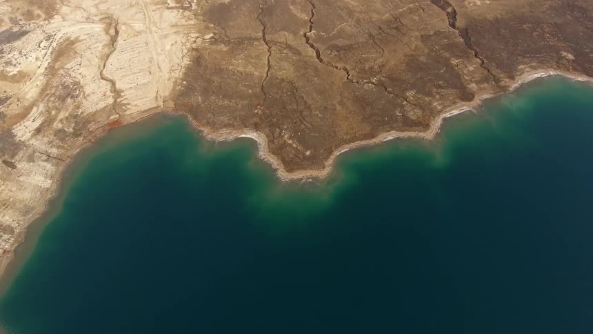 Aerial view of a green sea  coming to shore