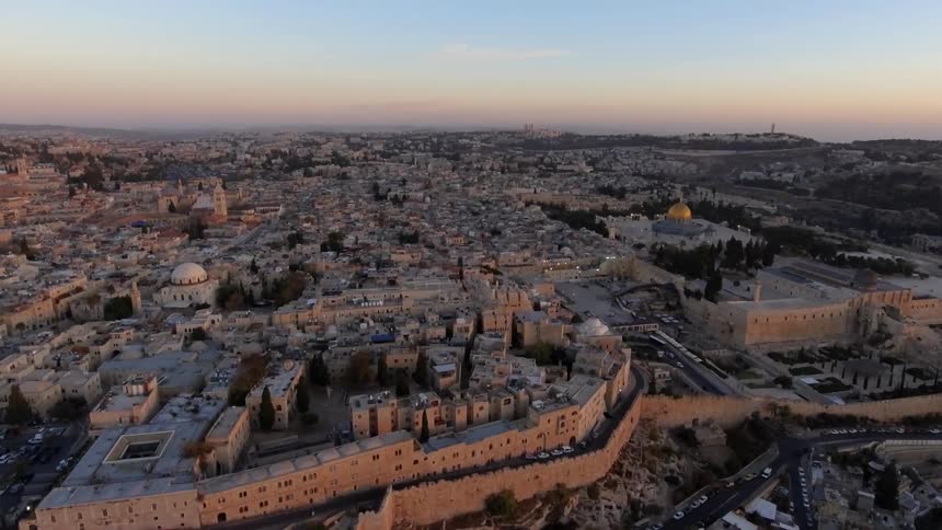 An old middle eastern city is seen from the air at dawn