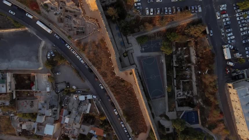 A car travelling along a road through a city