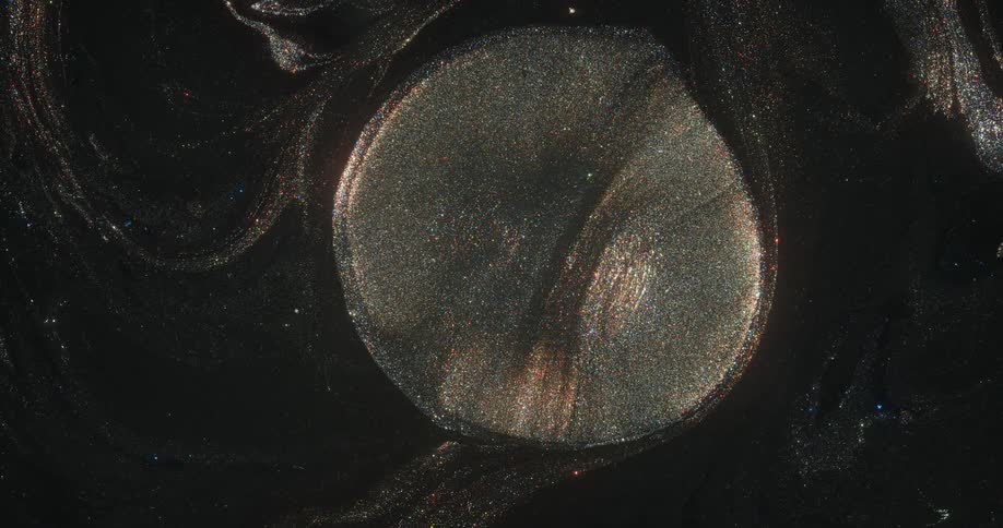 A circle of sparkling glitter moves in the night