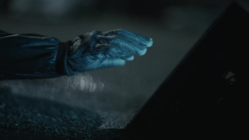A person touching a light at night outdoors